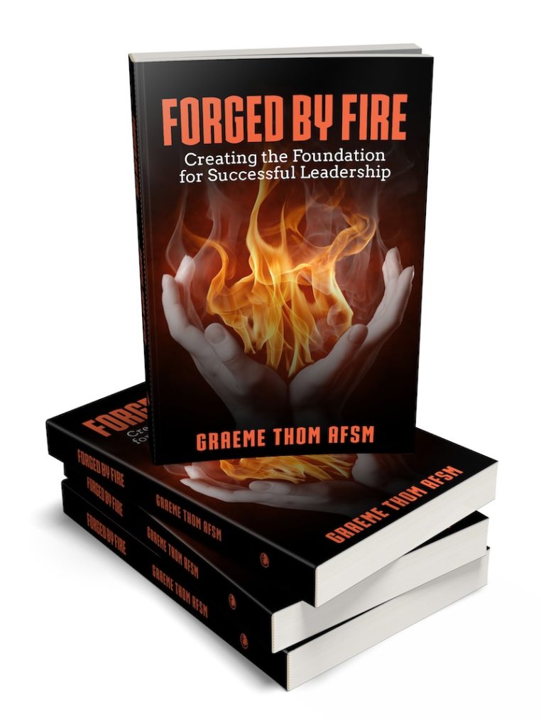 Forged By Fire book on a stack of books